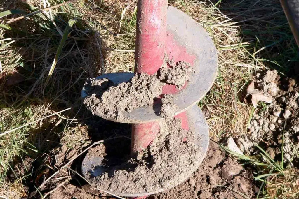 Auger digging through tree roots